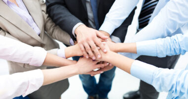Business people joining hands in circle Business people joining hands in circle